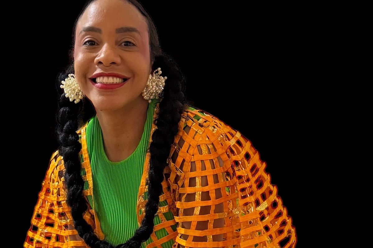 AnaQomSoul in an orange mesh jacket